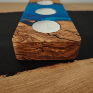 Olive wood tealight holder with blue epoxy on a black epoxy walnut desk