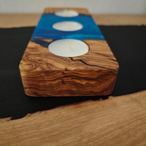 Blue tealight holder measuring 20 cm by 8 cm, placed on a desk, holding three tealights