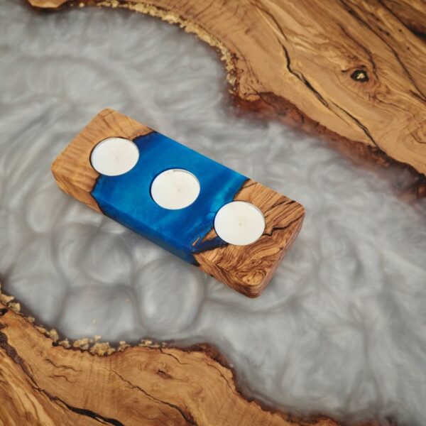 Blue tealight holder on a white table, measuring 20 cm by 8 cm, holding three tealights